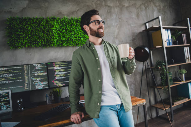 istock Portrait of professional hacker young man drink coffee think computer desk loft interior office indoors 2167012805