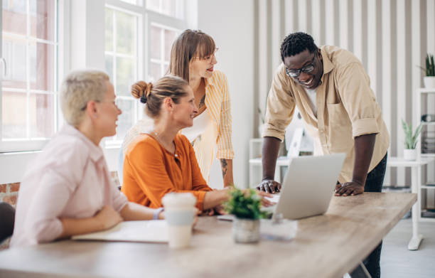 istock Four colleagues engaged in an office discussion 2167013164
