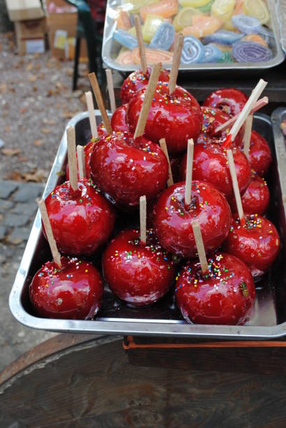 Red candy apples display on the street market.