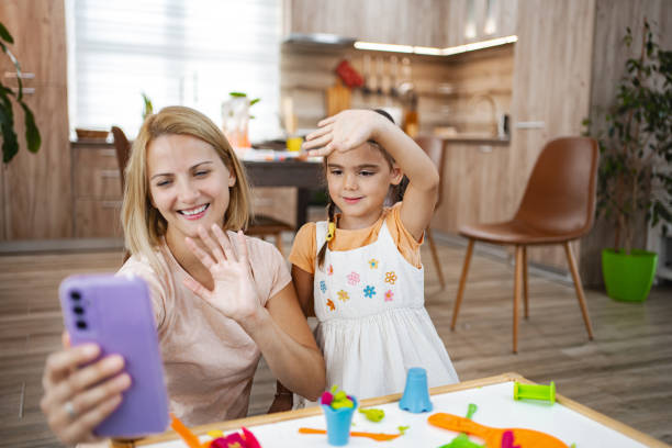 istock Joyful mother-daughter play during a call 2167013555