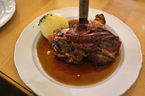 istock German cuisine: Schweinshaxe (roasted pork knuckle) with potato dumpling in Nuremberg, Germany 2167016163