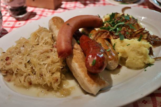 istock German cuisine: bratwurst (grilled pork sausages), mashed potatoes and sauerkraut (sour cabbage) in Munich, Germany 2167016390