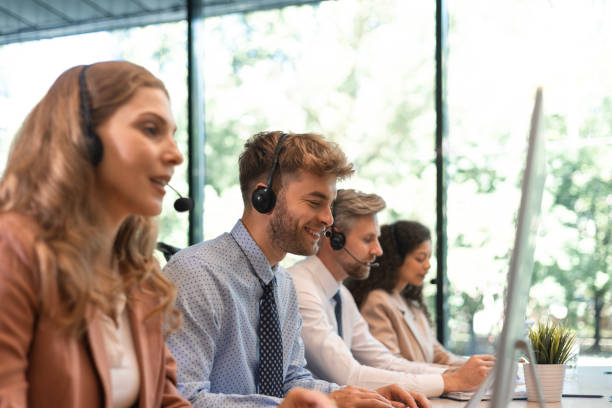 istock Portrait of call center worker accompanied by his team. Smiling customer support operator at work. 2167017542