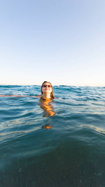 istock Woman immortalizes moment at sea during sunset 2167017718