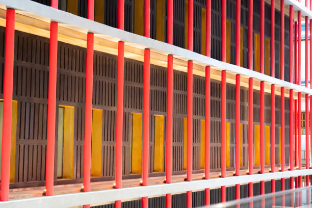 A large building surrounded by rows of sturdy red pillars.