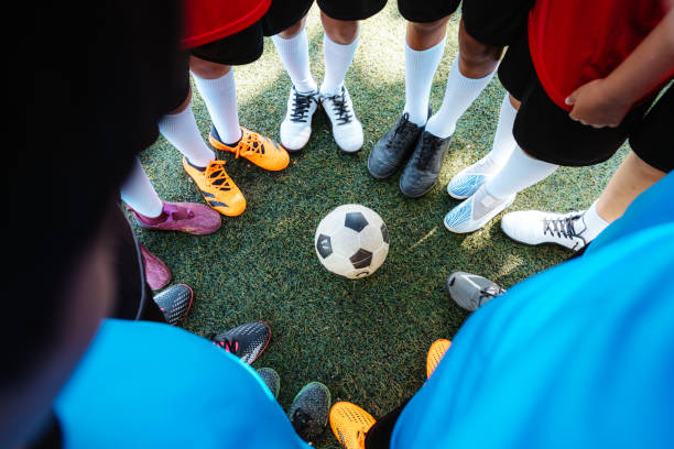 istock Team Huddle Around Soccer Ball on Field 2167019767