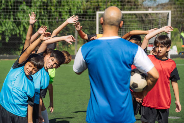 istock Youth Soccer Team Practicing with Coach on Sunny Day 2167019810