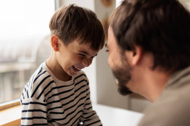 istock Father and son laughing together at home 2167021319