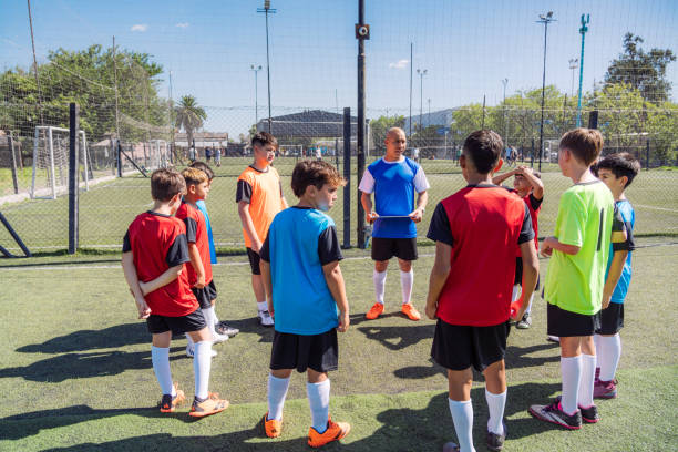 istock Youth Soccer Team Huddles with Coach for Strategy Session 2167022039
