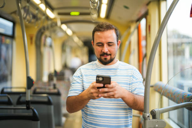 istock Man looking at his mobile phone on public transport 2167022068