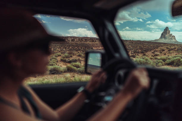 Traveling in Monument Valley, Arizona. The iconic rocky formations of the natural park viewed from a car, during a roadtrip