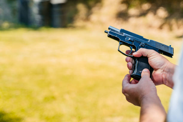 istock Mid-adult Man Reloading His Handgun Before Shooting 2167024047