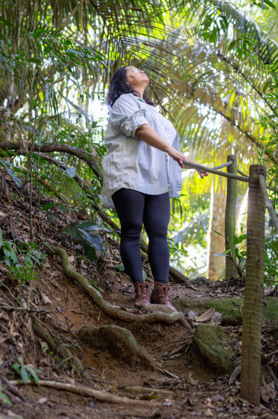 istock Beautiful woman descending difficult trail in the Amazon rainforest. 2167024244
