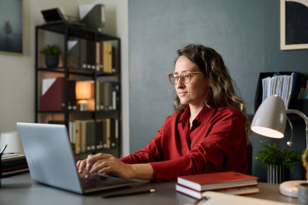 Caucasian Woman Using Laptop in Modern Office Environment