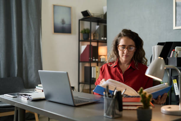 istock Concentrating Woman Working at Office Desk Without Distractions 2167024437