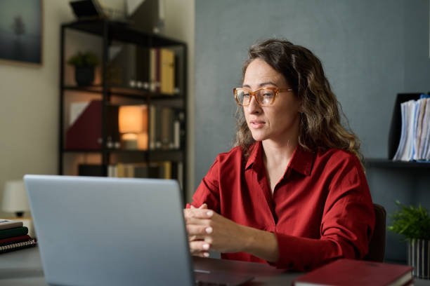 istock Concentrating on Serious Work at Office Desk with Laptop 2167024465