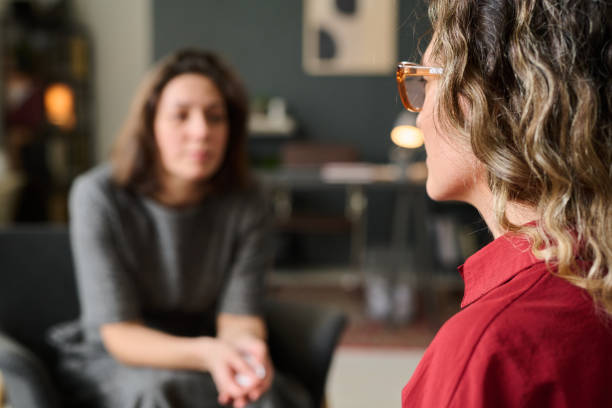 Engaging in Deep Conversation with a Counselor Two women engaging in a one-on-one counseling session in a cozy, well-lit room, one expressing herself while the other listens attentively. Background elements include furniture and decor \mental health stock pictures, royalty-free photos & images Engaging in Deep Conversation with a Counselor Two women engaging in a one-on-one counseling session in a cozy, well-lit room, one expressing herself while the other listens attentively. Background elements include furniture and decor \mental health stock pictures, royalty-free photos & images