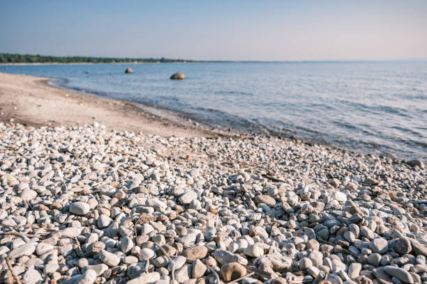 View of the pebble beach. Exterior of lake beach in Muskoka area of Ontario, Canada.