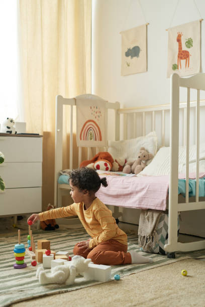 istock Child Playing with Toys in Cozy Bedroom Setting 2167026002