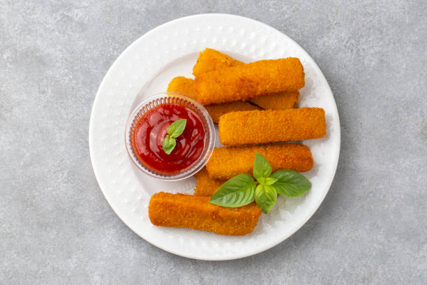 istock Fish and chips .Close up of crispy breaded deep fried fish fingers with breadcrumbs served with remoulade sauce and lemon 2167026006
