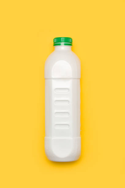 istock A white plastic bottle with a green lid on a yellow background 2167026733