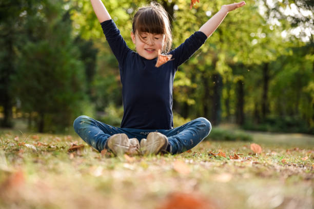 istock Girl having fun throwing autumn leaves 2167027247