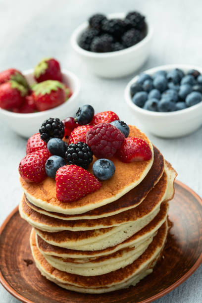 istock Stack of homemade american pancakes with berries . Top view 2167028067