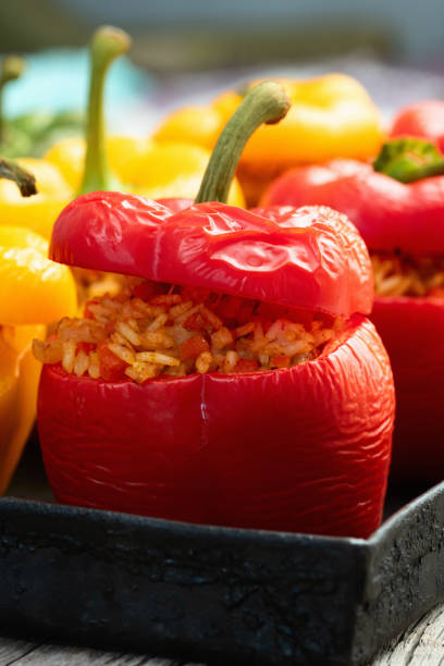istock Baked stuffed pepper ( paprika ) with rice , carrot and meat . Top view on rustic background 2167028100