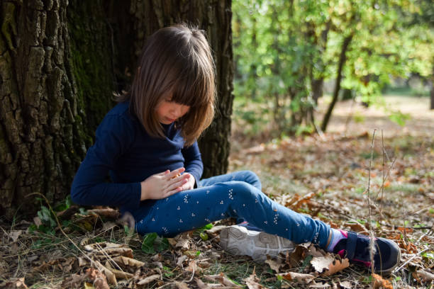 istock Girl sitting under oak tree and holding oak nuts 2167029447
