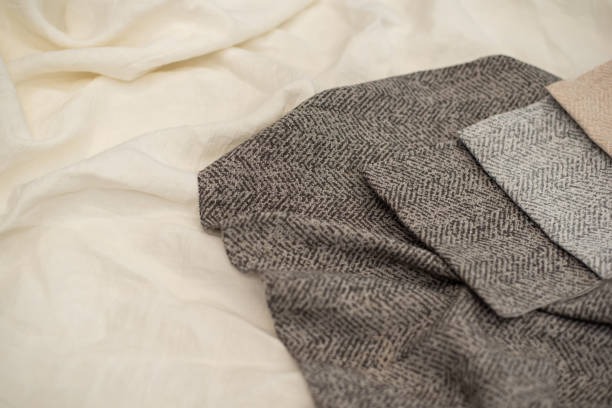 istock Gray textured fabric for curtains close-up. Tissue samples on a milky background. 2167032514