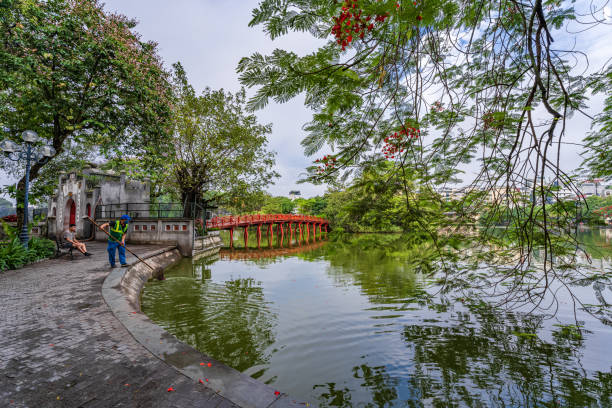 Hoan Kiem lake or Sword lake, Ho Guom in Hanoi, Vietnam with Turtle Tower, on clear day with blue sky and white clouds Hanoi, Vietnam - 26 June 2024 : Hoan Kiem lake or Sword lake, Ho Guom in Hanoi, Vietnam with Turtle Tower, on clear day with blue sky and white clouds ho guom stock pictures, royalty-free photos & images