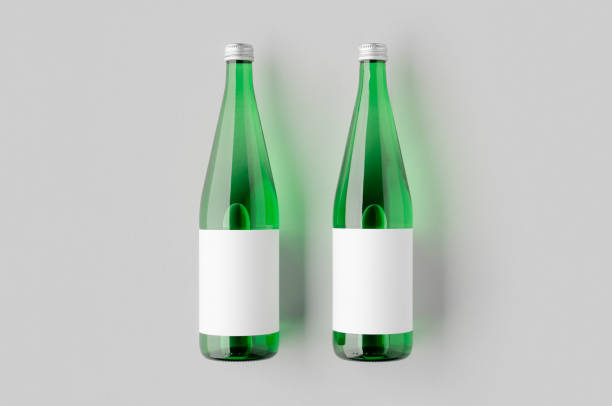 istock Green glass water bottle mockup with a blank label. 2167035397