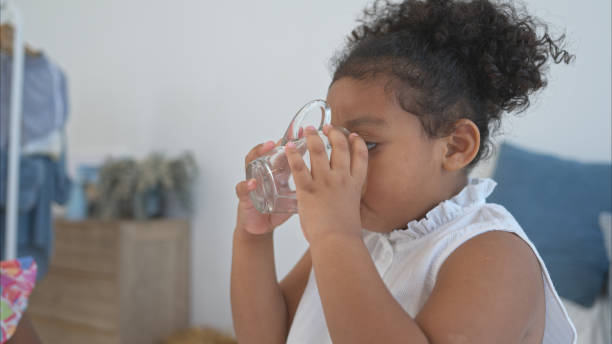 istock A tiny girl drink milk before bed in the bedroom 2167035472