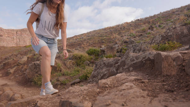 Young woman hikes mountain pathway, Madeira
