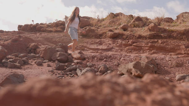 Young woman hikes mountain pathway, Madeira