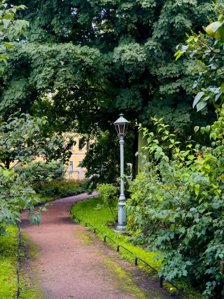 istock Vintage Lantern Amidst Lush Greenery in a Serene Park Setting 2167040237