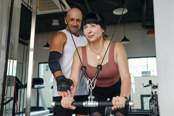 istock Woman Training With Personal Trainer In Gym 2167041927
