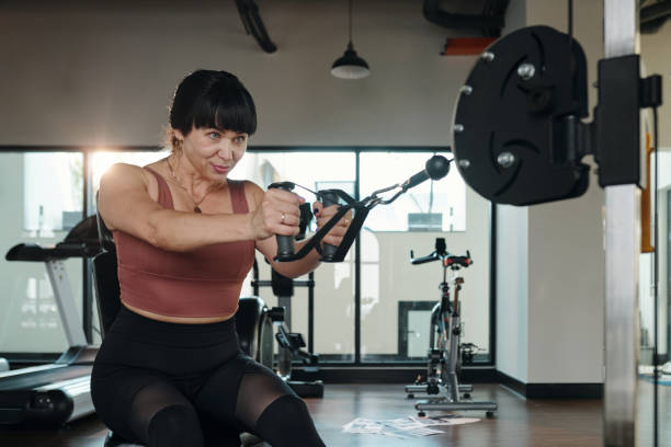 istock Woman Exercising With Weights In Gym 2167041933