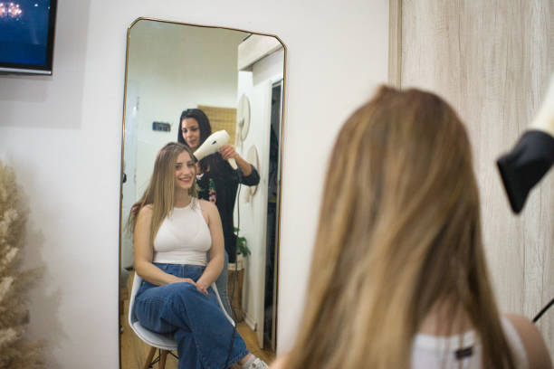 istock Smiling client in front of hairdressing mirror 2167042478
