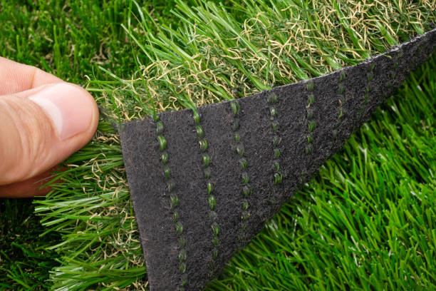 istock Fingers Lifting Edge of Artificial Grass 2167047539