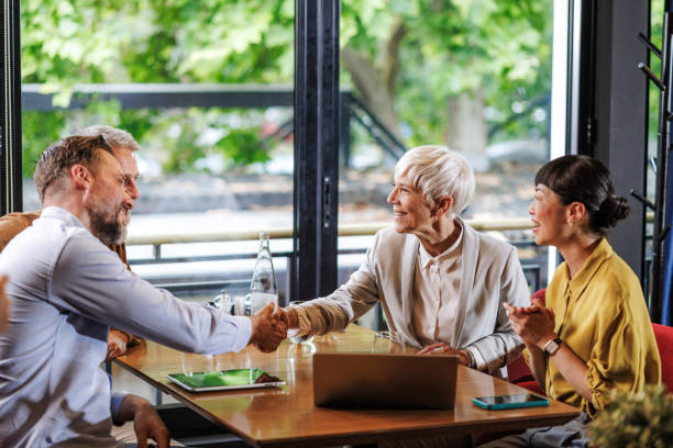 istock Businesspeople handshaking at a restaurant 2167048553