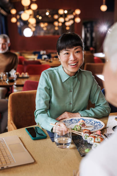 istock Friends enjoying dinner at a Japanese restaurant 2167048567