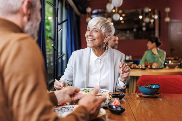 Senior woman enjoying dinner at a restaurant