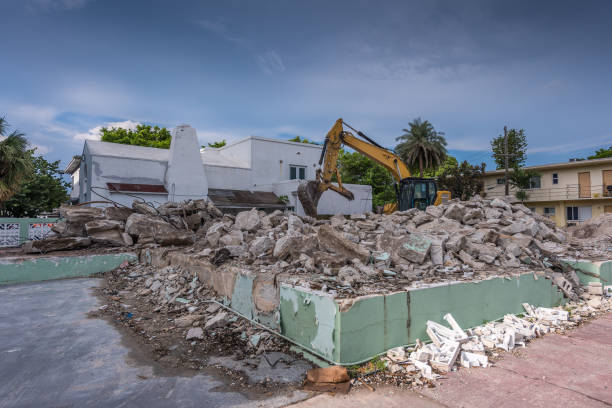 Backhoe climbed on a building rubble pile, April 23/2022