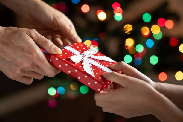 istock Christmas gift giving between parent and child 2167056812