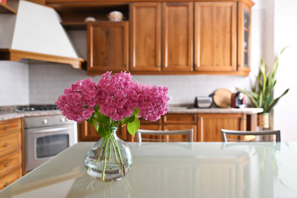 Beautiful bouquet with hydrangea flowers on glass table in the kithen room