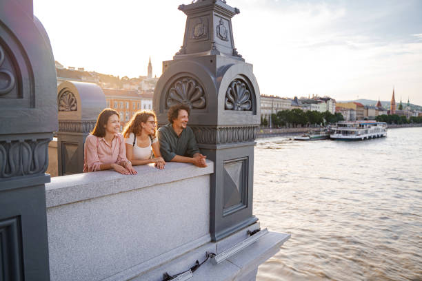 Friends laugh and take in the sunset along the Danube River in Budapest.
