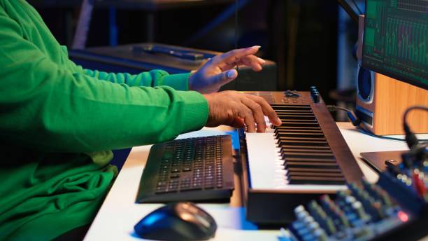istock African american audio technician using piano synthesizer keys to add effects 2167065859