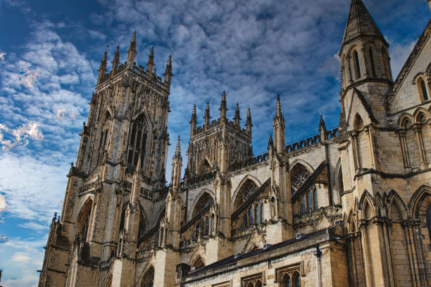 istock Gothic cathedral tower against a dramatic cloudy sky, showcasing intricate architectural details and spires, ideal for historical or religious themes in York, North Yorkshire, England. 2167065971