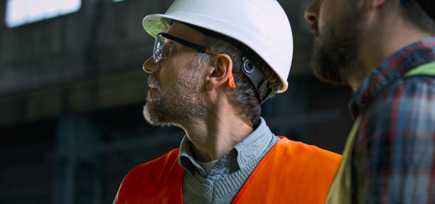 istock Close up of two industry technicians looking at industrial equipment 2167066080